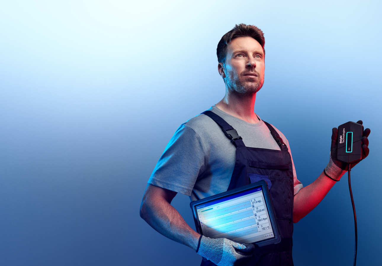 A mechanic holding a diagnostic tool