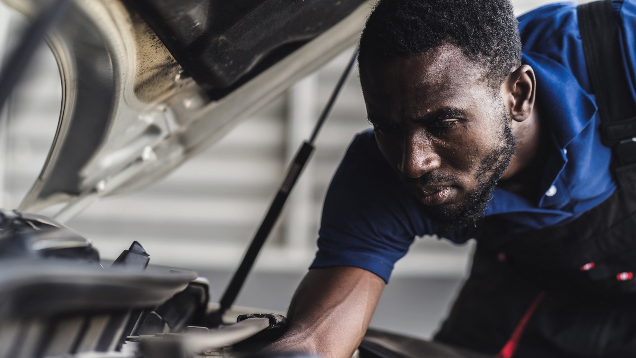 technician fixing a car
